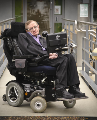 Immagine che ritrae Stephen Hawking sulla sua sedia a rotelle con sintetizzatore vocale